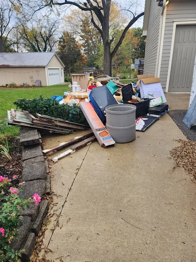 Dumpster being loaded with debris for 10 Yard Dumpster Rental in Centre